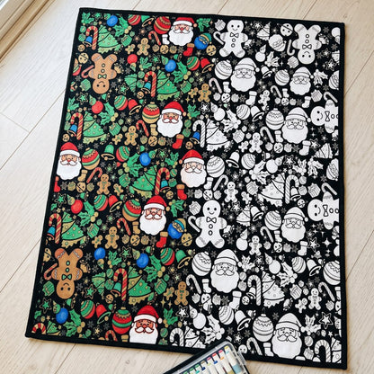 The blanket laid flat, half of the drawings colored in and half still black and white